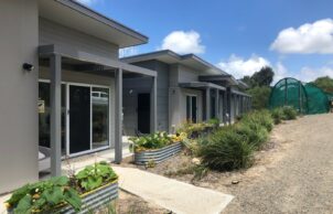 Front-of-house-and-wicking-beds-designed-to-blend-with-environment-302x194